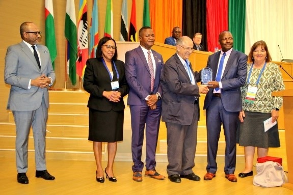 Dr Sherif Sadek (Egypt) receiving a token of appreciation from Hon. Makozo Chikote during the Honors and Awards ceremony